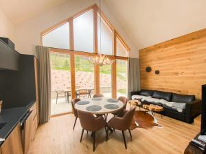 a living room with a table and chairs at Chalet Bela in Bohinjska Bela