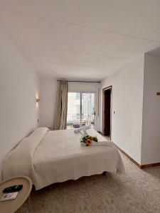 a bedroom with a large bed with flowers on it at Pensió Anna in Tossa de Mar +7 photos
