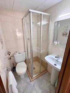 a bathroom with a shower and a toilet and a sink at Pensió Anna in Tossa de Mar