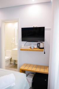 a room with a bed and a television on a wall at Golden Beach Guest House & Rooftop Bar in Faro +161 photos