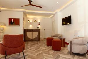 a living room with orange chairs and a ceiling at Hostal Jakiton in Palmanova