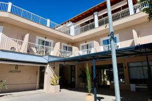 an exterior view of a building with balconies at Hostal Jakiton in Palmanova