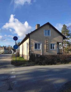 a house on the side of a street with a blue sign at Economy stay - Self Check-in in Vaasa