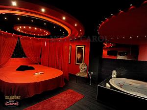 a red room with a bed and a tub at Carol Hotel in Piraeus +82 photos
