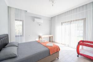 a bedroom with a bed and a large window at Villa Zara in Mergenli +19 photos