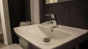 a bathroom with a white sink and a mirror at City Apartment - Perfect for two in Tåstrup