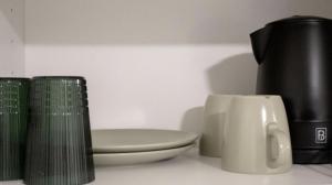 a bathroom with a toilet and a coffee pot and a cup at City Apartment - Perfect for two in Tåstrup