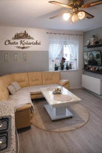 a living room with a couch and a table at Chata košaríska in Oščadnica