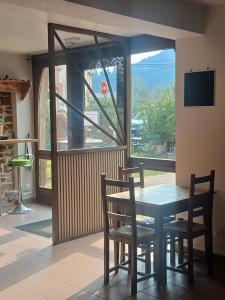 a dining room with a table and chairs and a window at L'auberge du Houx in La Houssière