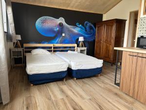 a bedroom with a bed with an octopus on the wall at Sam Va in Dolus-d'Oléron