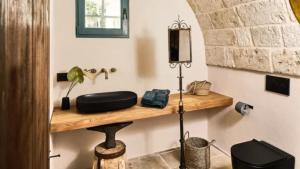 a room with a wooden shelf on a wall at Bambarone L'Agriturismo in Fasano +25 photos