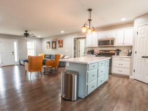 an open kitchen and living room with white cabinets at Haven Hill House - Scenic Getaway near Bardstown & Bourbon Trail in Springfield