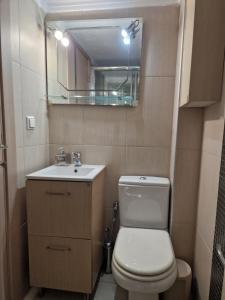 a bathroom with a toilet and a sink and a mirror at Lela's House in Yerakiní +5 photos