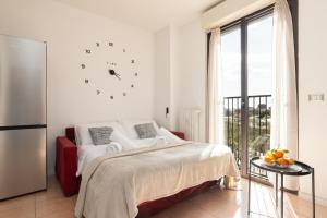 a bedroom with a bed and a clock on the wall at Milano Lux Apartament - Private Indoor Parking in Sesto San Giovanni