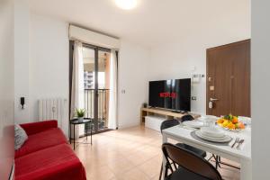 a living room with a red couch and a table at Milano Lux Apartament - Private Indoor Parking in Sesto San Giovanni +31 photos