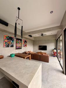 a living room with a table and a couch at Villa Donald in Canggu