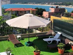 a large white umbrella on top of a roof at Villa Rocky in Sozopol