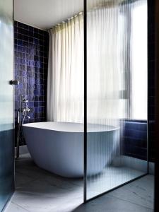 a bath tub in a bathroom with a window at Bus Palladium in Paris