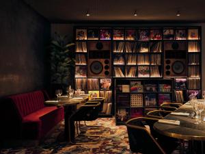 a restaurant with tables and chairs and a book shelf at Bus Palladium in Paris