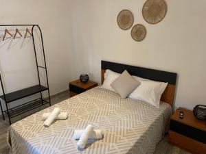 a bedroom with a bed with two towels on it at Alojamento A Cascata in Vidigueira +6 photos