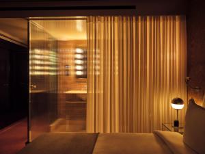 a bedroom with a bed and a glass shower at Bus Palladium in Paris +39 photos