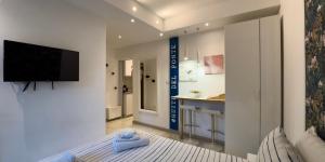 a bedroom with a bed and a tv on a wall at BelSorrisoVarese - Rooms & Apartments - Private Parking - Reservation Required in Varese