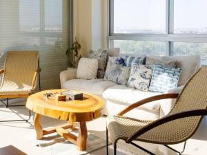 a living room with a couch and a table and chairs at On the Malecón with ocean lagoon & pool in Mazatlán