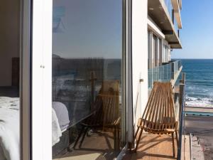 a balcony with a view of the ocean at On the Malecón with ocean lagoon & pool in Mazatlán
