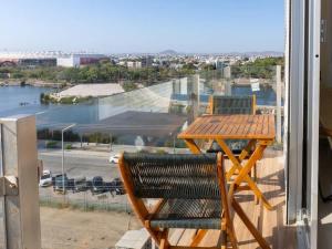 a balcony with a table and chairs and a view of a harbor at On the Malecón with ocean lagoon & pool in Mazatlán +25 photos
