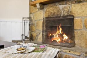 a table with two plates of food and a fireplace at Working 9 to Pine by Beyond Expectations with Views in Sevierville