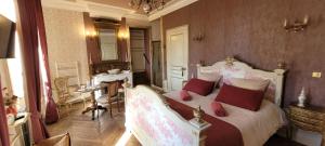 a bedroom with a bed with red pillows and a mirror at Château St Sulpice Chambre Porcelaine in Condal