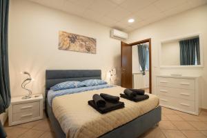 a bedroom with a bed with towels on it at Mary s House Cerveteri Wifi AC in Cerveteri