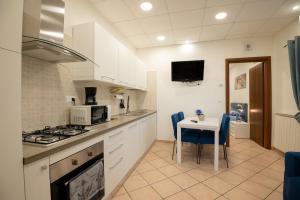 a kitchen with a table and a stove top oven at Mary s House Cerveteri Wifi AC in Cerveteri +14 photos