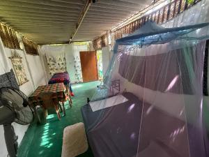a room with a tent and a table and chairs at Jungle Room in Talalla South
