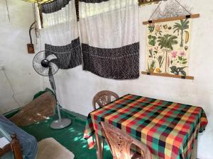 a room with a table and a lamp and window at Jungle Room in Talalla South