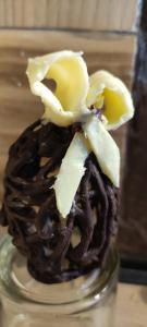 a chocolate cupcake with a flower on top of it at Maison d´hôtes La Dromandise in Saint-Arcons-de-Barges