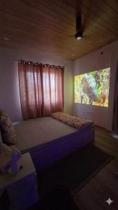 a bedroom with a bed with a picture of an elephant at Rewind by NestoraHomes in Jadgenhalli