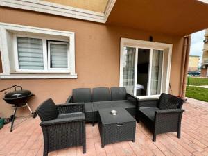 a patio with chairs and a table and a grill at Nori Studio #Garden&Pool in Ştefăneştii de Sus