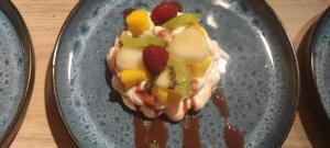 a dessert with fruit on a plate on a table at Maison d´hôtes La Dromandise in Saint-Arcons-de-Barges