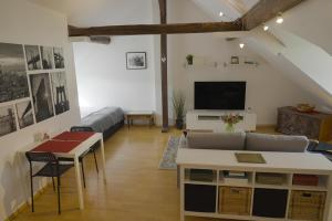 a living room with a couch and a tv at Dachgeschosswohnung in Hannover