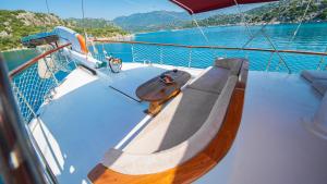 a bench on the deck of a boat in the water at Cakabey Yachting in Demre +2 photos