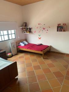a bedroom with a red bed in the corner of a room at Cabaña AWA in Puerto Salgar +1 photo