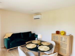 a living room with a table and a couch at Au loft, micro maison vue sur prairie in Rohrwiller +29 photos