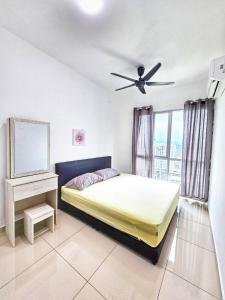a bedroom with a bed and a ceiling fan at Metropol Holiday Suite in Bukit Mertajam +10 photos