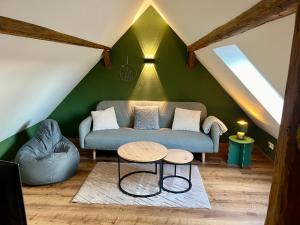 a living room with a couch and a table at Ferienhaus Schwalmblick in Schwalmstadt