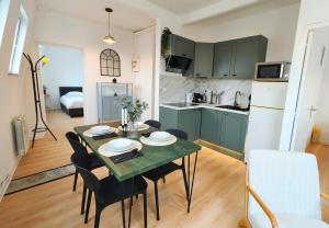 a kitchen and dining room with a table and chairs at L'Éclat du Miroir - AbsoluteHome in Croix
