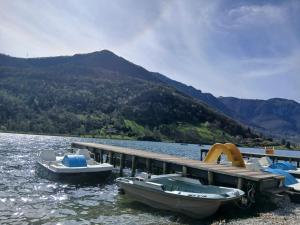two boats are docked at a dock on a lake at CasaEndine in Ranzanico
