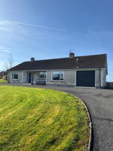 a house with a green lawn in front of it at Erne View Lodge in Lisnaskea