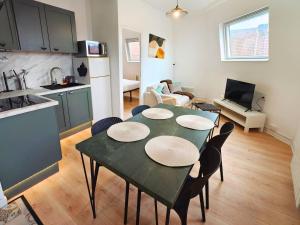 a kitchen and a living room with a table and chairs at L'Éclat du Miroir - AbsoluteHome in Croix +5 photos