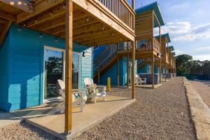 a blue house with a deck and chairs on the sidewalk at The Container Retreat - 6A.. in Canyon Lake